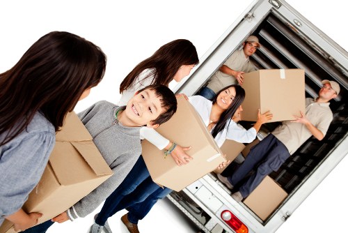 Man with van loading furniture for a local move in Ealing