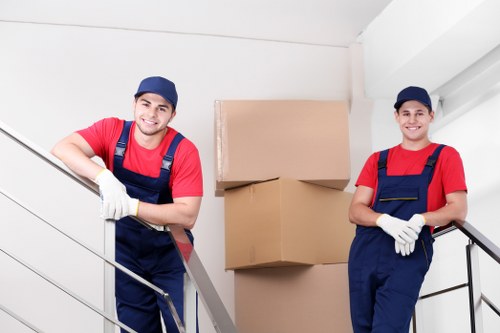 Removal team handling boxes and furniture in Ealing