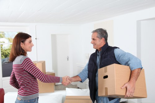 Local removals team handling boxes in a West London street